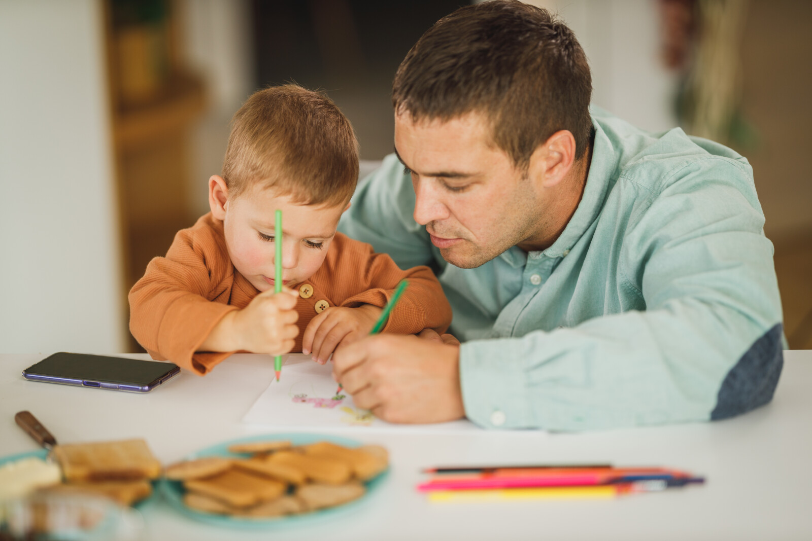 Preschool student and his parent working on an activity together