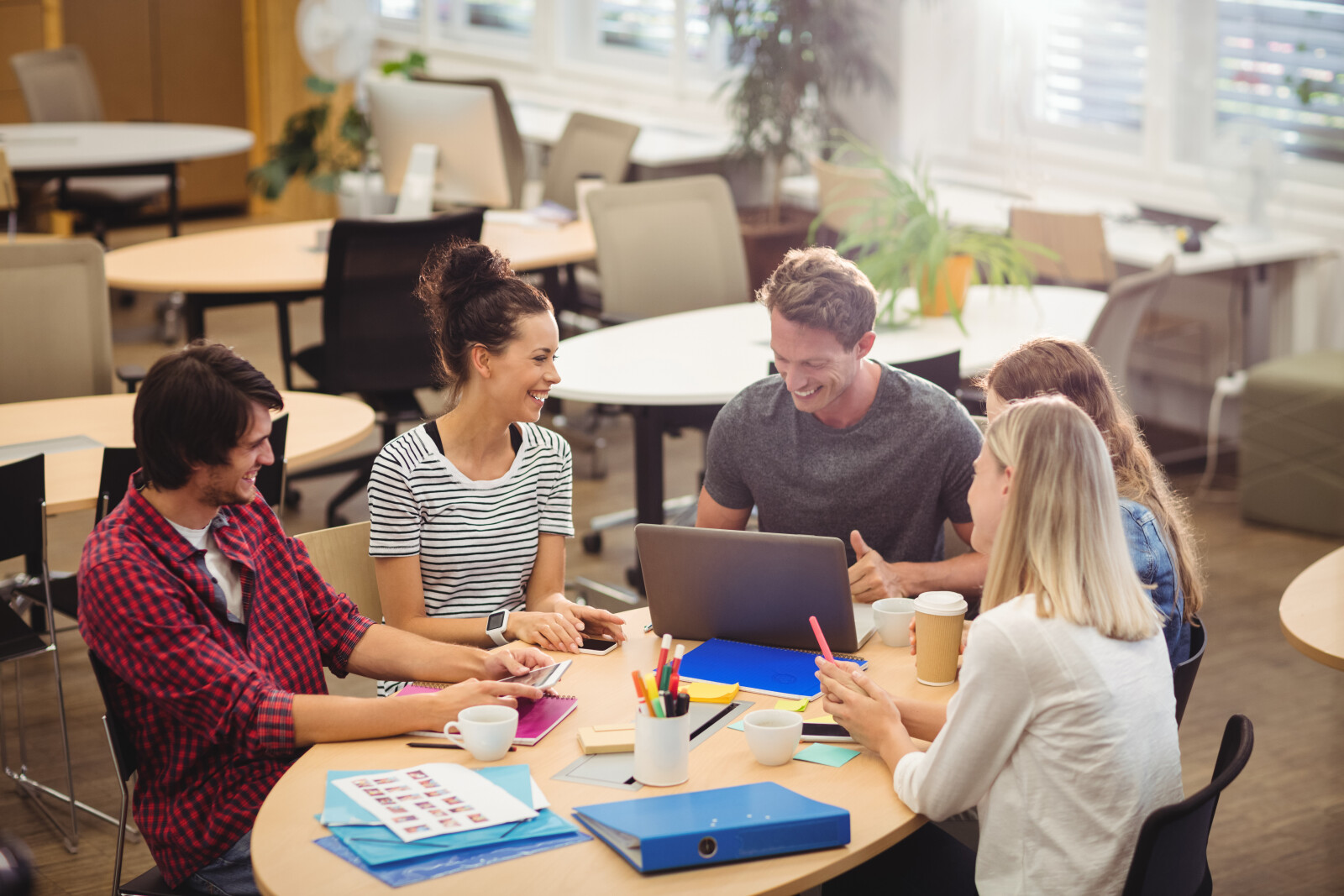 School staff in a meeting discussing fundraising software